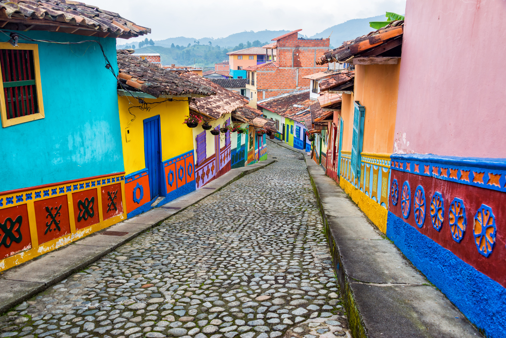 Colorful houses line a cobblestone street in Guatape, Colombia, which is one of the most dangerous countries to visit in South America