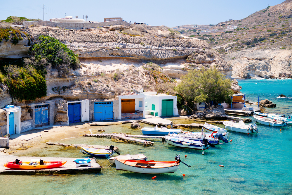 Boats on the water in a traditional bay of the Greek island of Milos