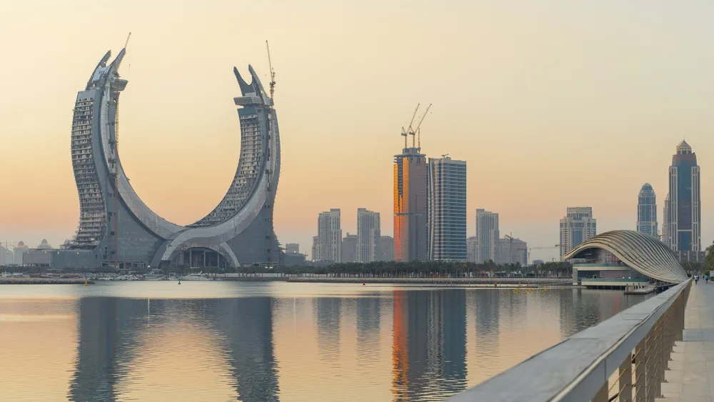 Lusail Marina Park at dusk shows curving skyscrapers reflecting on the Persian Gulf during the best time to visit Qatar