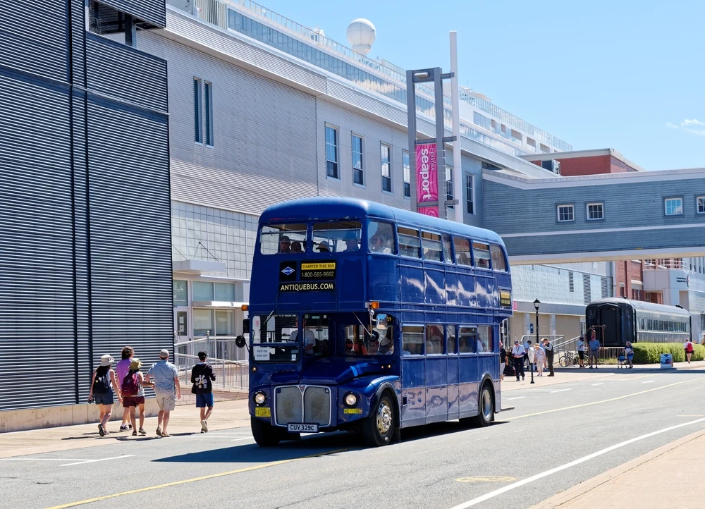 Giant blue double-decker bus pictured driving along the downtown area in Nova Scotia