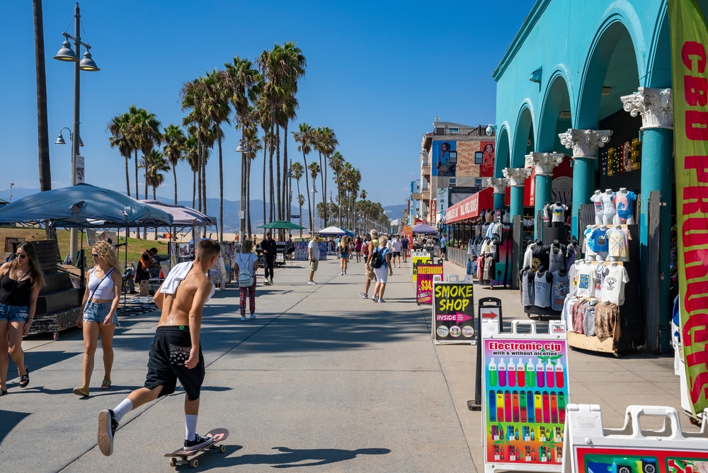 Photo of poeple walking on the boardwalk during September, the least busy time to visit Los Angeles