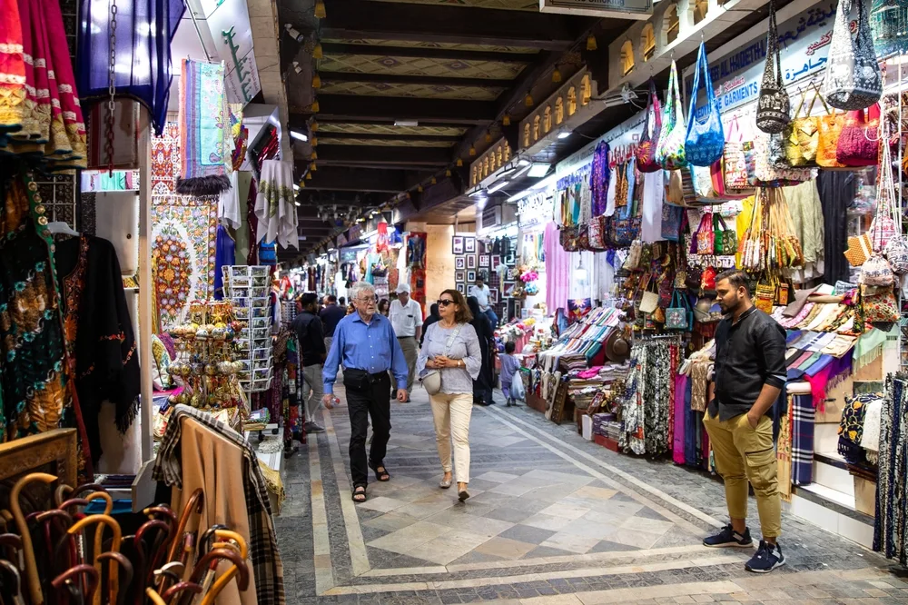 Tourists walking in the Muttrah Souq in Muscat for a piece titled Is Oman Safe to Visit