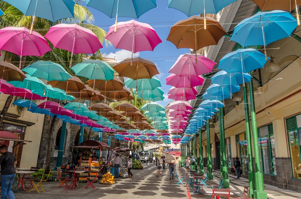 Red and blue umbrellas pictured above the shopping district in Port Louis, Mauritius
