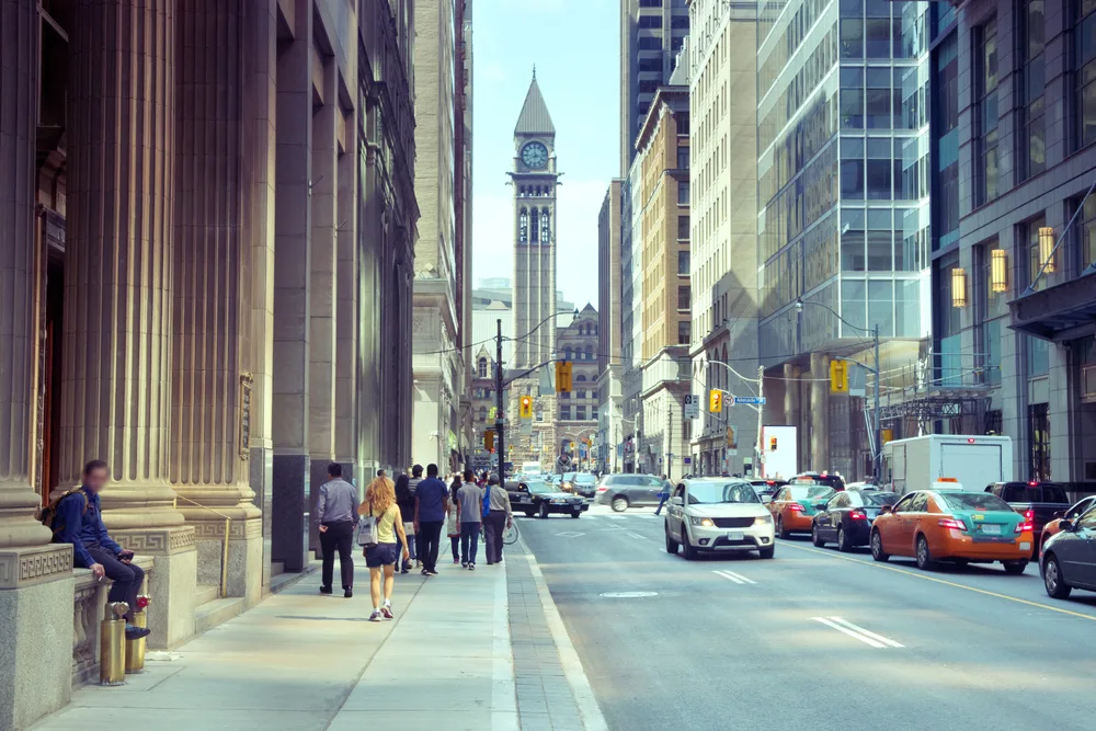 Image for a guide to whether or not Canada is safe to visit featuring a street as seen from the perspective of a pedestrian walking along next to traffic