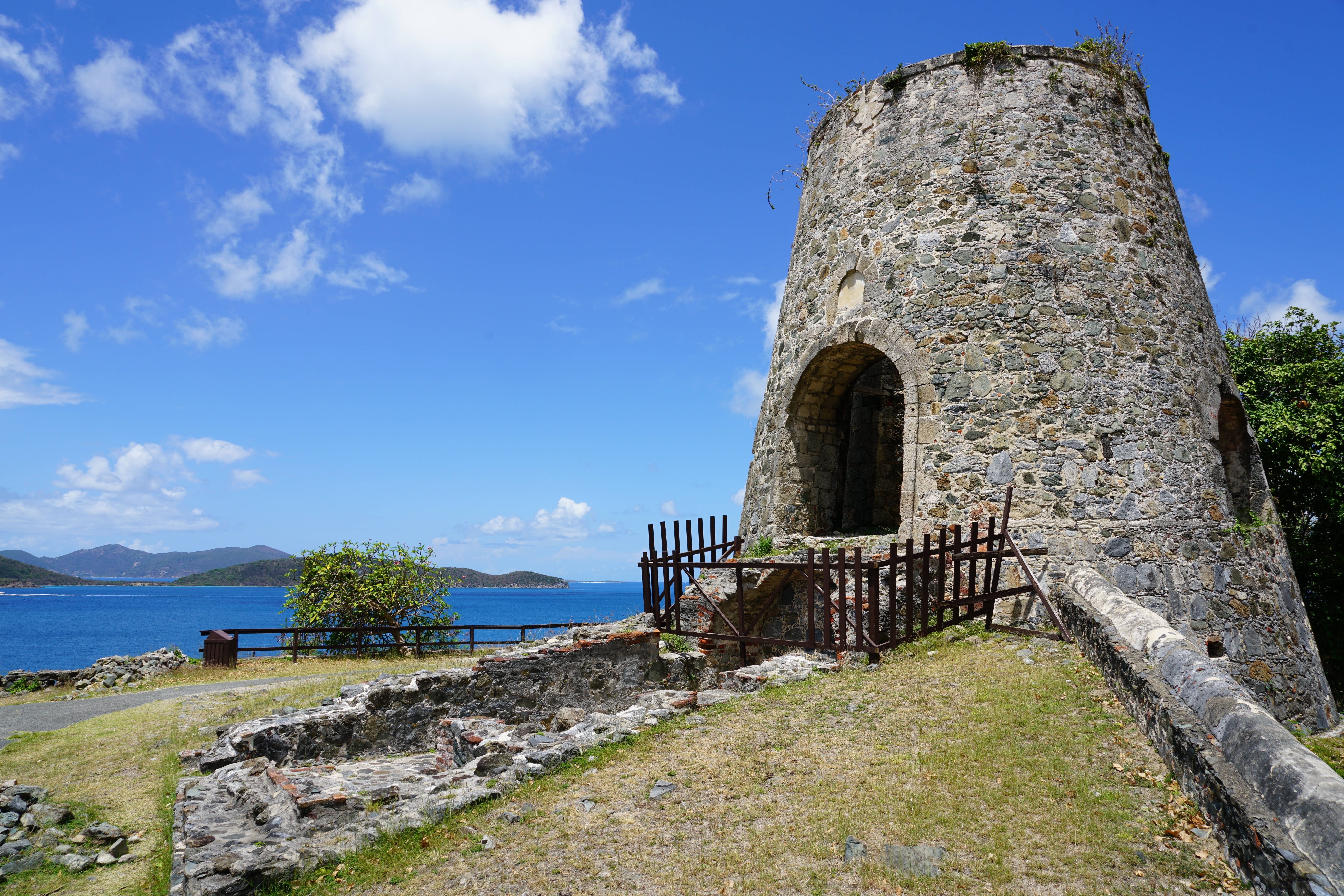 Annaberg sugar plantation ruins in stone overlooking the sea in Virgin Islands National Park on St. John, USVI with blue skies overhead showing the cheapest time to visit St. John 