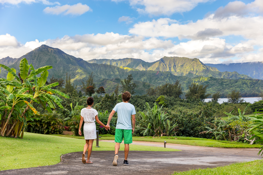Tourists walking along the walking path in Kauai for a piece titled Where to Stay in Kauai