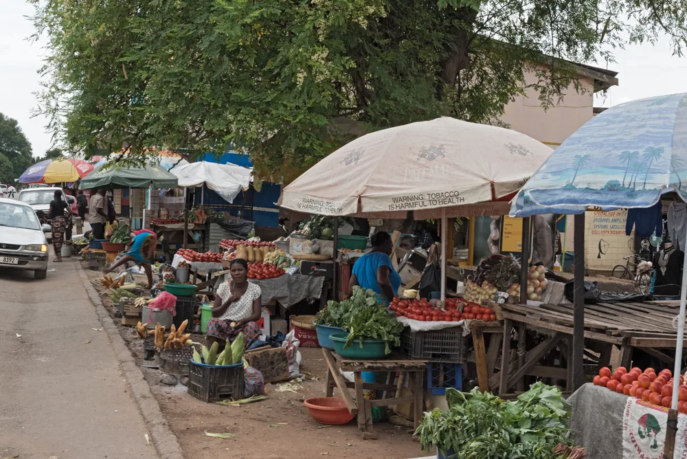 Vendors selling their goods on a roadside market under umbrellas in Livingstone to help illustrate that Zambia is fairly safe to visit