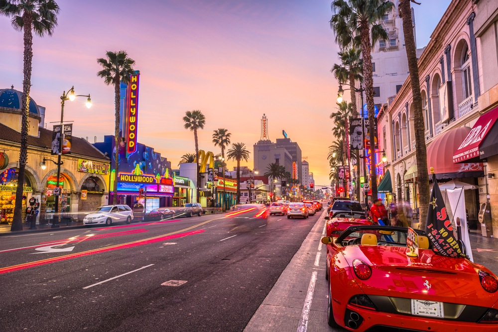 Luxury cars outside the strip malls in the theater district of Los Angeles on Hollywood Boulevard