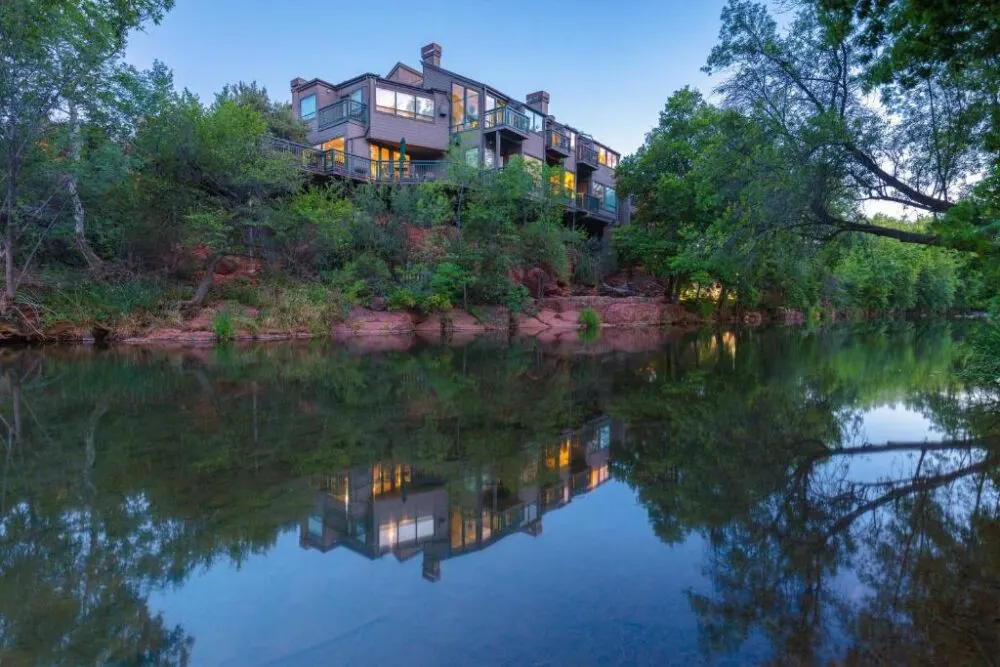 For a piece on the best boutique hotels in Sedona, a photo of the outside of the Inn Above Oak Creek reflecting in the water