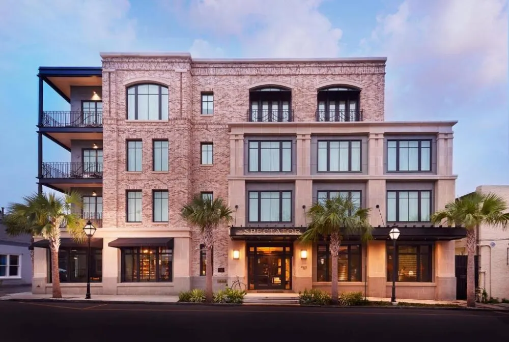 For a roundup of the best boutique hotels in Charleston SC, the exterior of the Spectator Hotel is shown