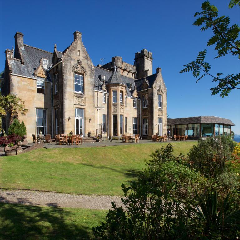 For a roundup of the best castle hotels in Scotland, the Stonefield Castle Hotel pictured from the shade of the trees looking toward the structure
