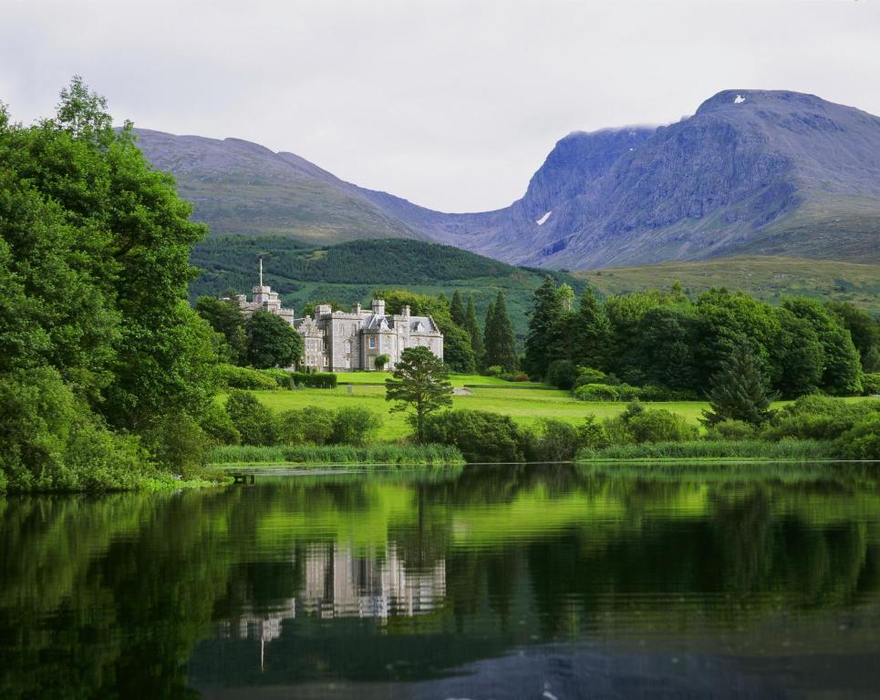 Picturesque view of the Inverlochy Castle Hotel in Scotland as seen from across the pond