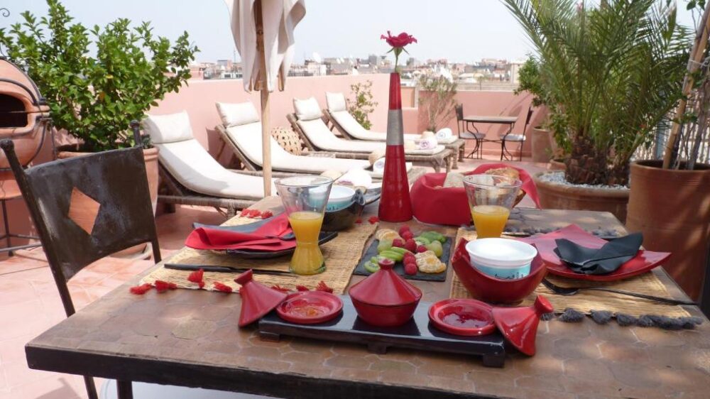 Rooftop of the Dar Andamaure, one of Marrakech's best riads, pictured with red porcelain on a table