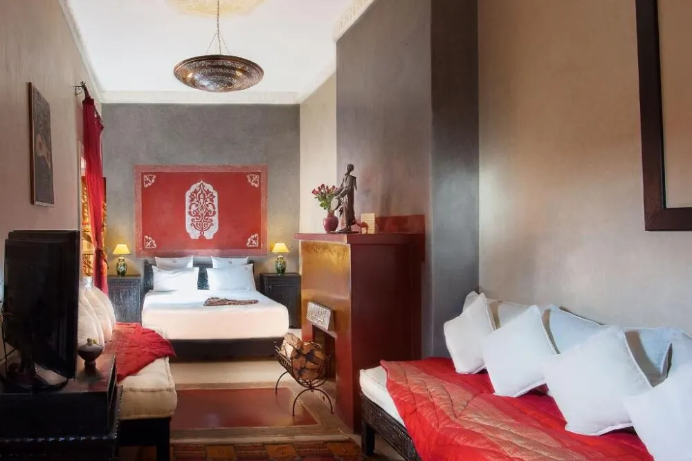 Room in the Riad Alili, one of the best riads in Marrakech, pictured with red and white bedding
