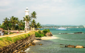 Featured image for a piece titled Is Sri Lanka Safe to Visit featuring the Galle Gort Lighthouse towering over the choppy teal water below