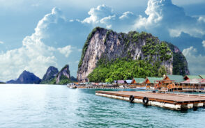Featured image for a piece titled Is Phuket Safe to Visit featuring Gypsy Beach in a semi-artistic style image with floating docks next to the floating huts