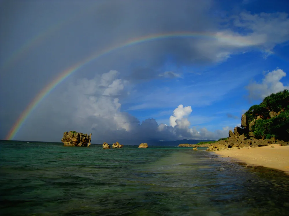 Photo of a rainbow stretched above the island of Kouri on Okinawa