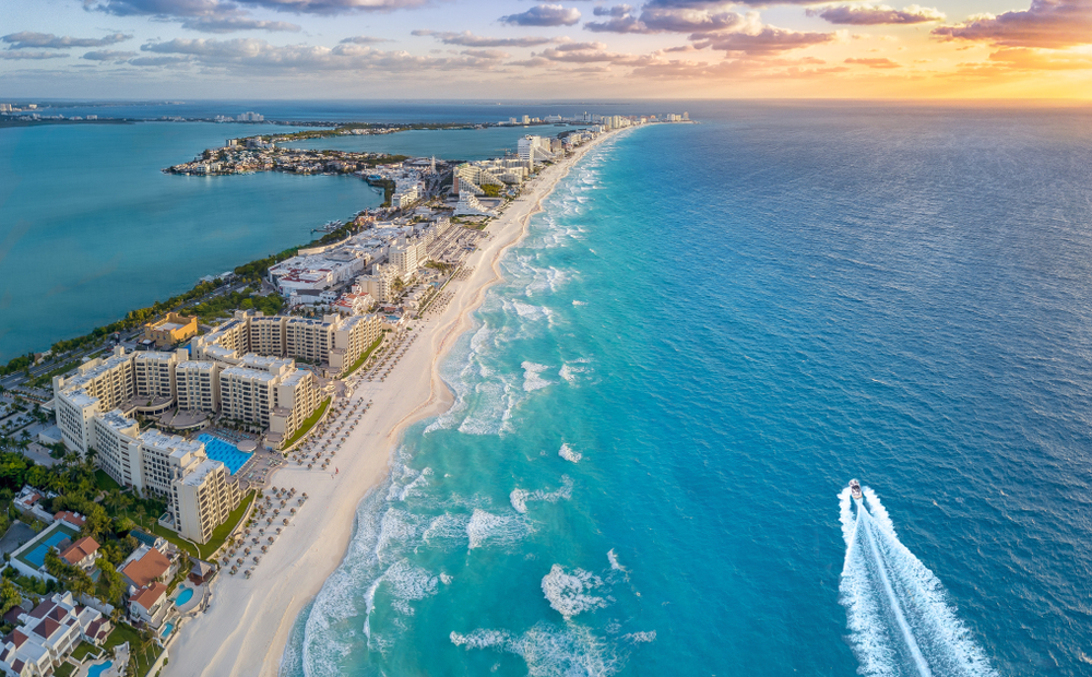 Cancun hotel zone aerial view at sunset shows this popular destination as one of the cheapest places you can fly to