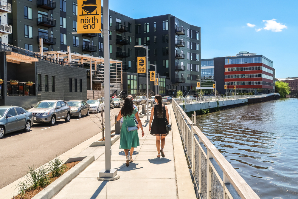 Two attractive young women walking along the riverwalk in East Town, one of the best areas to stay when in Milwaukee