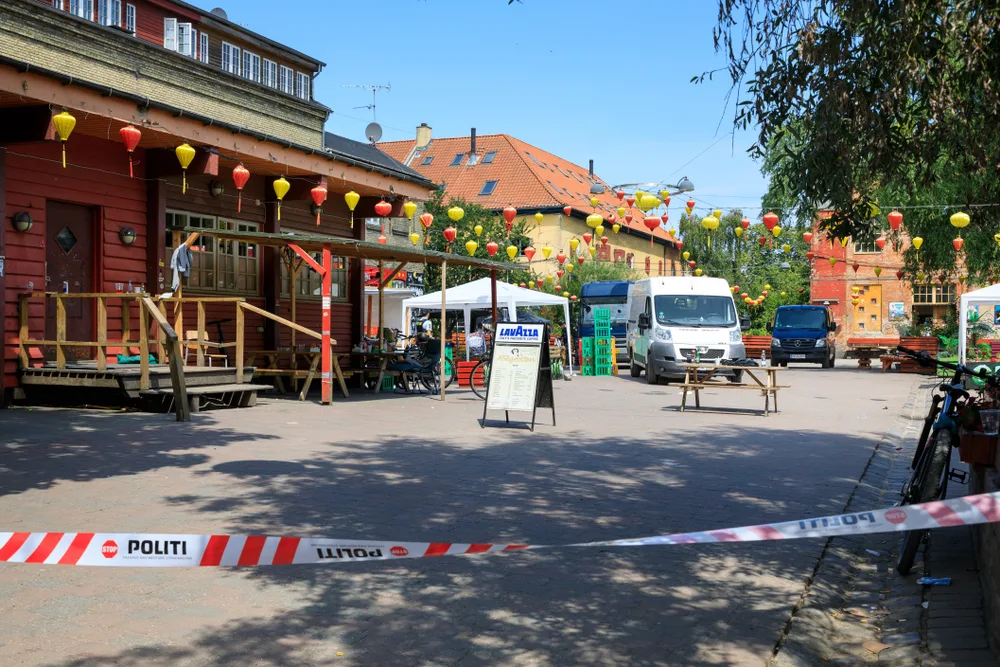 Police raid the anarchist town of Christiania with signs and police trucks all over to illustrate the bad parts of Copenhagen