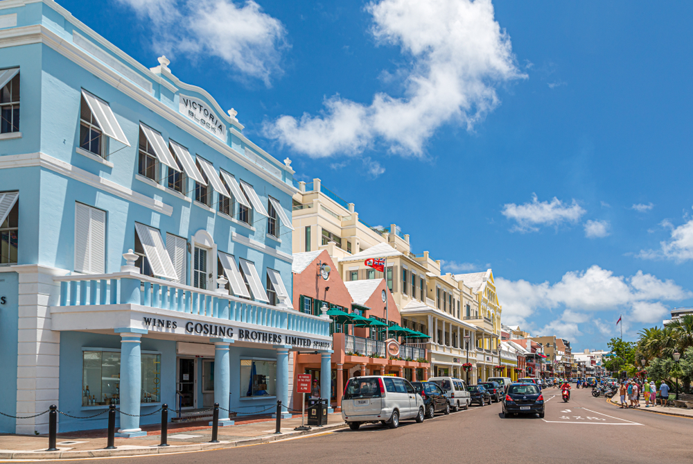 Shopping center in Hamilton pictured with colorful pastel buildings below a clear blue sky for a piece on whether or not Bermuda is safe to visit
