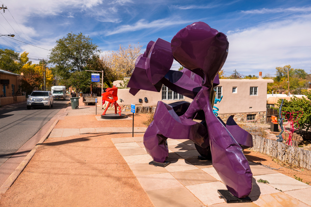 Big purple metal sculpture pictured in the middle of the walkway for a piece on whether Santa Fe is safe to visit