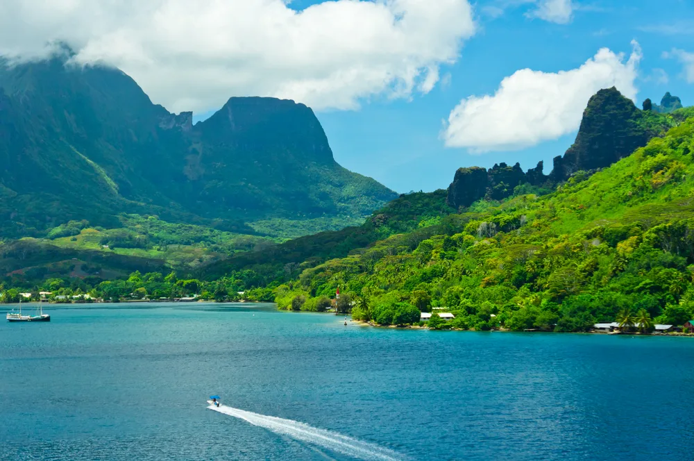 Boat motors along on the clear blue water in Moorea for a guide to whether French Polynesia is safe to visit or not