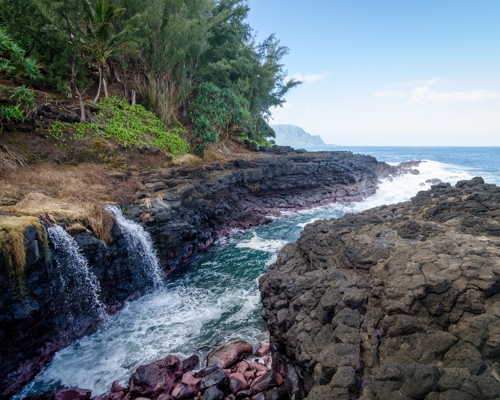 Colorful scene with the Queen's bath in full view, flowing out into the ocean. One of the areas to be extremely careful in while in Kauai