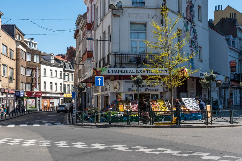 As seen from the crosswalk in the middle of the street, the Saint-Josse area in Brussels is depicted as one of the least safe areas to visit in Belgium