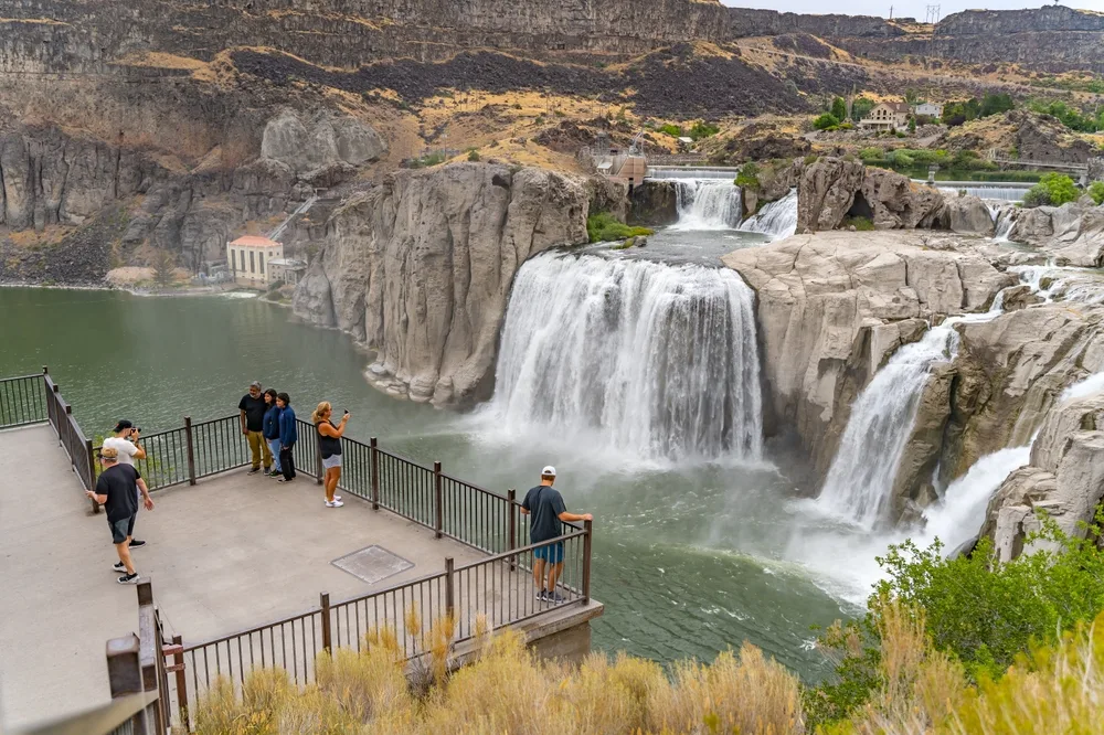 Photo of people mulling about on the bridge over the Shoshone Falls during the best time to visit