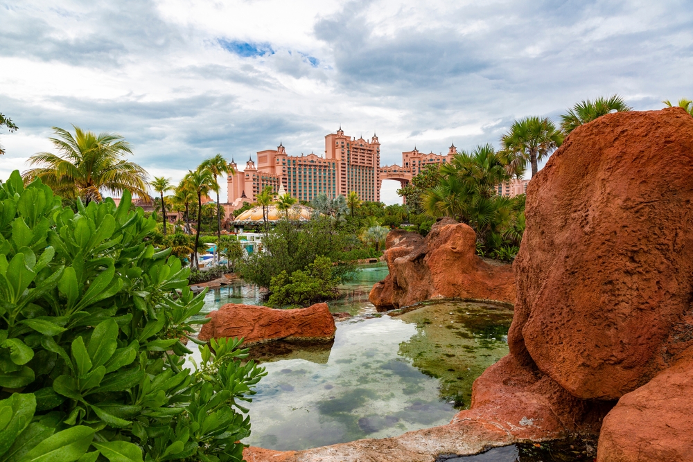 Neat view of the Atlantis hotel pictured from behind red rocks looking up toward the room tower