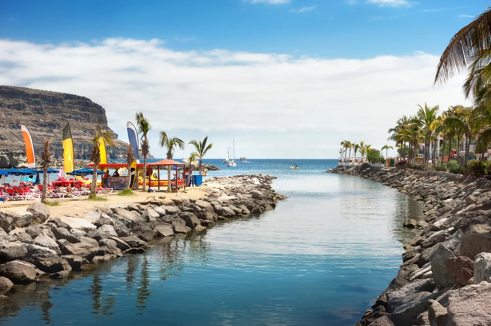 Neat view of the still water between the rocky coastline in Puerto Mogan, Gran Canaria