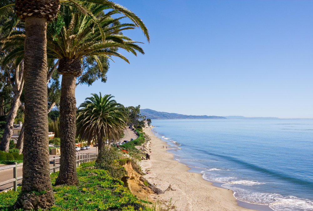 Santa Barbara's Butterfly Beach on Channel Drive shown on a clear, sunny day to show one of the best US vacation spots to visit on the Pacific Coast