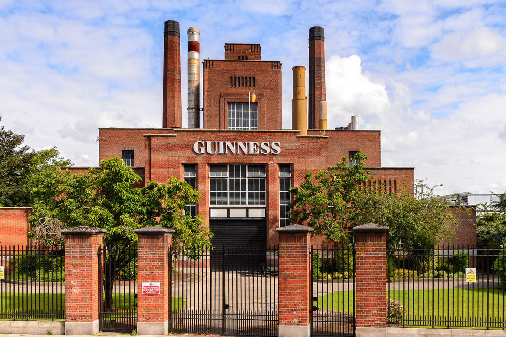 For a guide titled is Dublin safe to visit, a photo of the outside of the Guinness brewery pictured against a blue sky