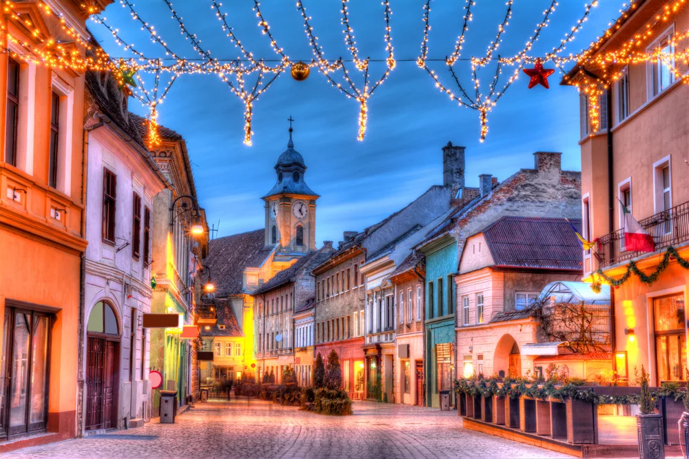 Christmas on romantic Michael Weiss Street in Brasov, in Transylvania, during the winter, the overall cheapest time to visit Romania