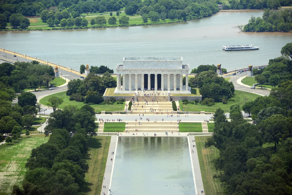 Aerial view of the Lincoln Memorial with people walking around on the steps in front, an attraction within walking distance of some of the best boutique hotels in Washington DC