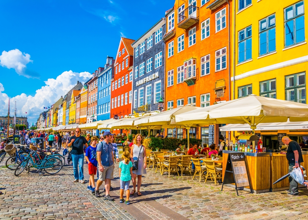 People mulling about in the open-air marketplace of the Nyhavn port in the central part of the city for a guide titled Is Copenhagen Safe to Visit