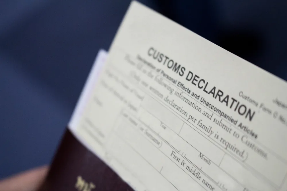 Blurred image of a Customs Declaration Form that must be filled out as one of the steps of going through customs at the airport