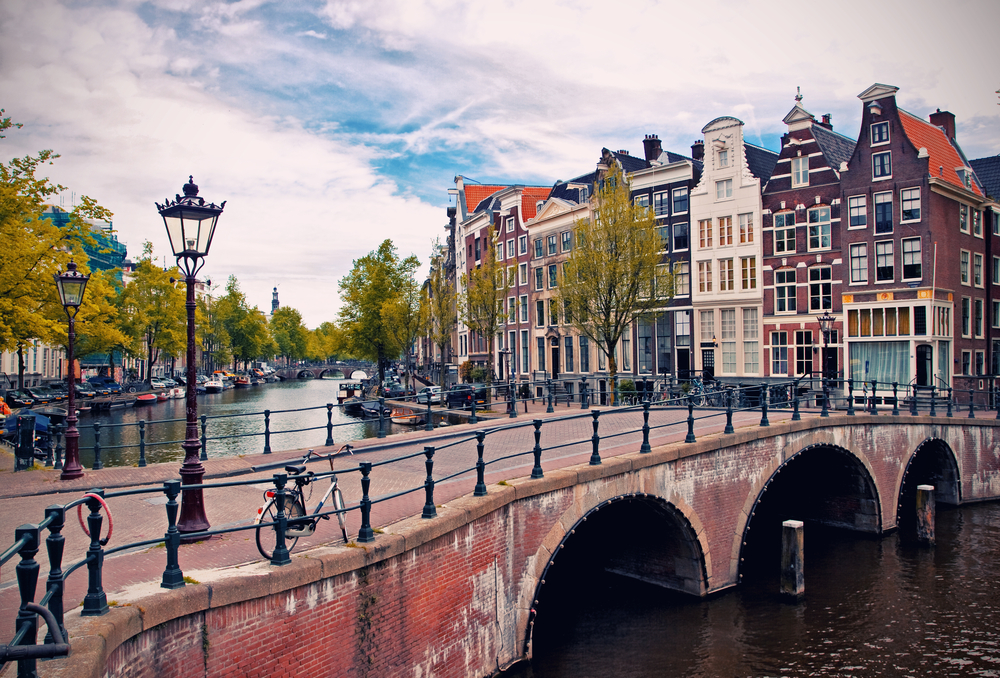 Amsterdam canals with bridges crossing and colorful buildings on the edge show why it's one of the best cities to visit in Europe