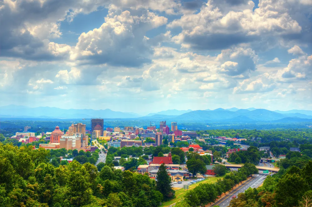 Asheville, NC skyline with the mountains in the distance on a cloudy day for a list of the best places for couples vacations