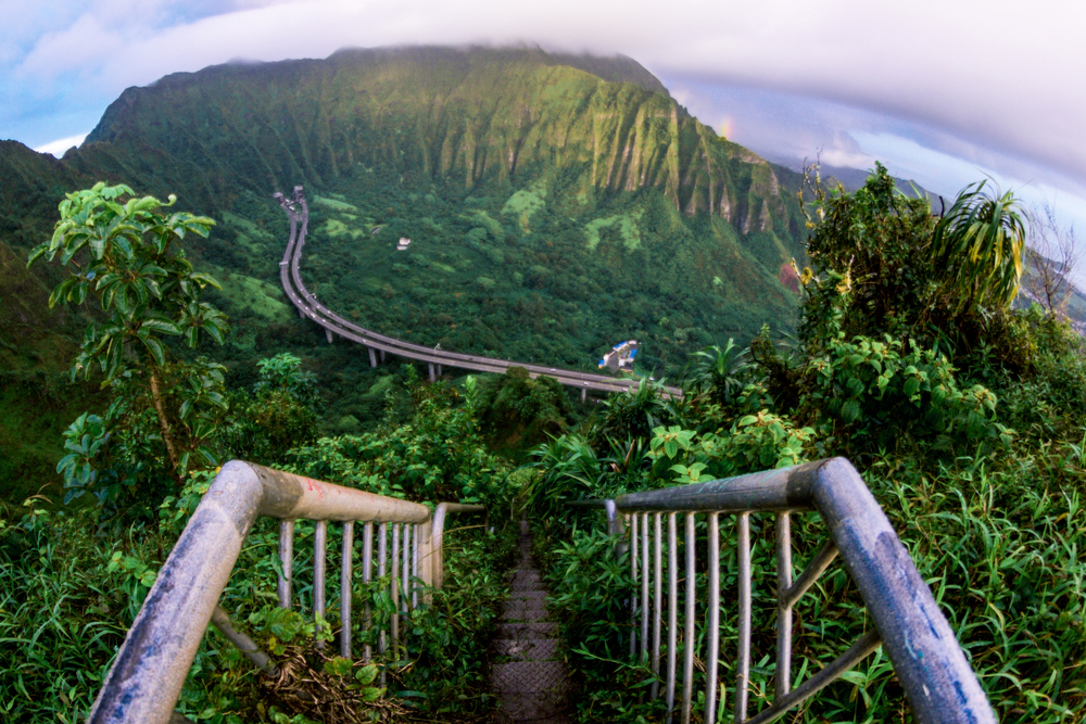 Popular Stairway to Heaven on Oahu pictured with its metal railings going up from the valley below