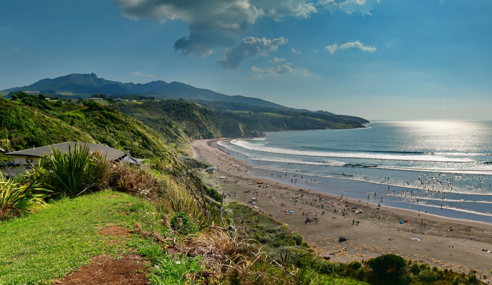 Beautiful black sand beach in Raglan New Zealand, one of the country's best areas to stay