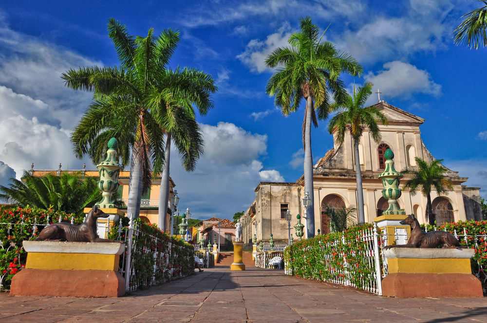 Old historical buildings in Trinidad pictured for a guide titled Cost of a Trip to Cuba