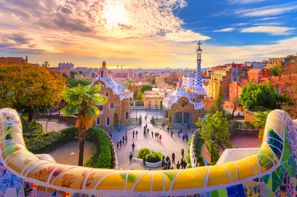 View of Barcelona from Park Guell with colorful tiles visible in the foreground for a list of the 10 best cities to visit in Europe 
