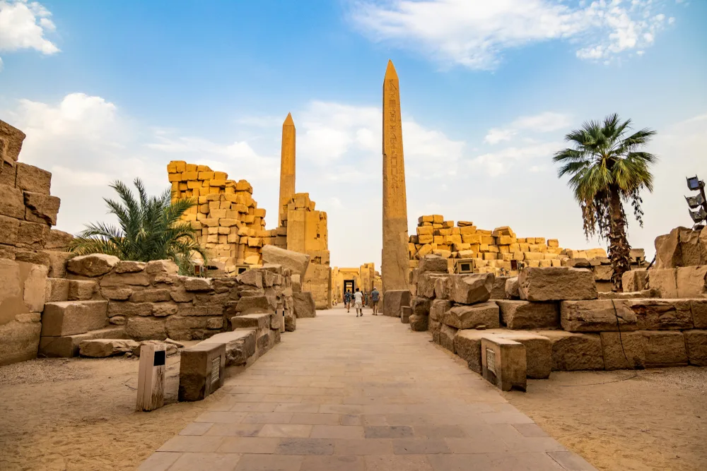 Neat view of the walkway to the Karnak Temple pictured on a nice day with a semi-clear sky overhead