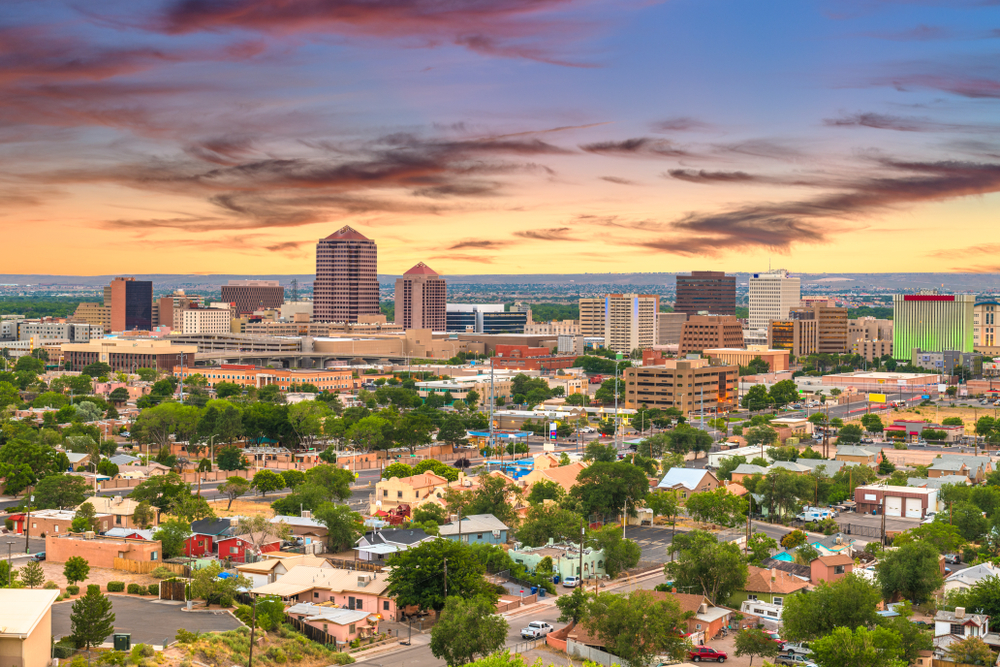 Aerial view of Albuquerque, NM at dusk with clouds in the colorful sky highlight one of the top cheap places to travel within the United States