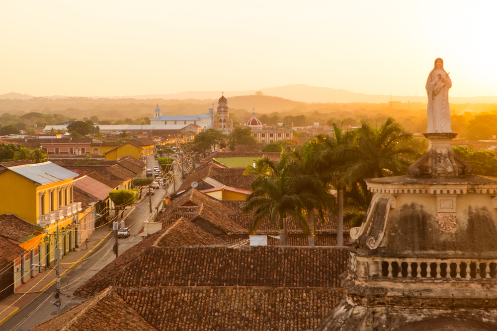 Gorgeous golden sunlight over the picturesque city of Granada in Nicaragua for a guide to whether the country is safe to visit