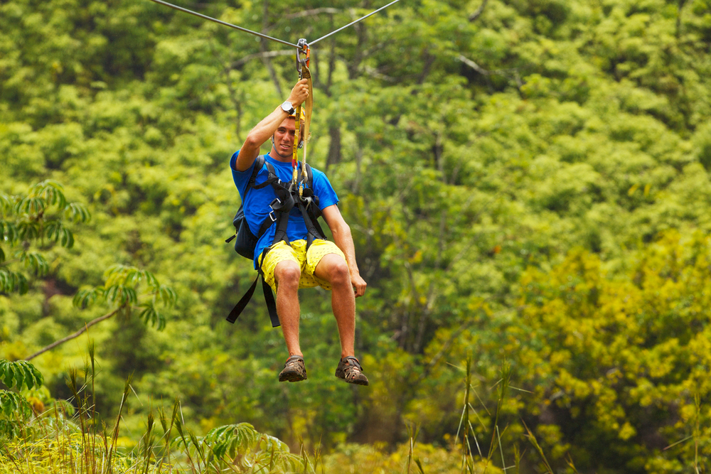 Happy guy ziplining over the Big Island
