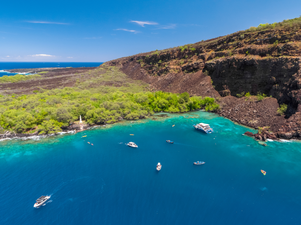 Aerial view of snorkeling boats parked at Kealakekua Bay, one of the best activities to do on the Big Island