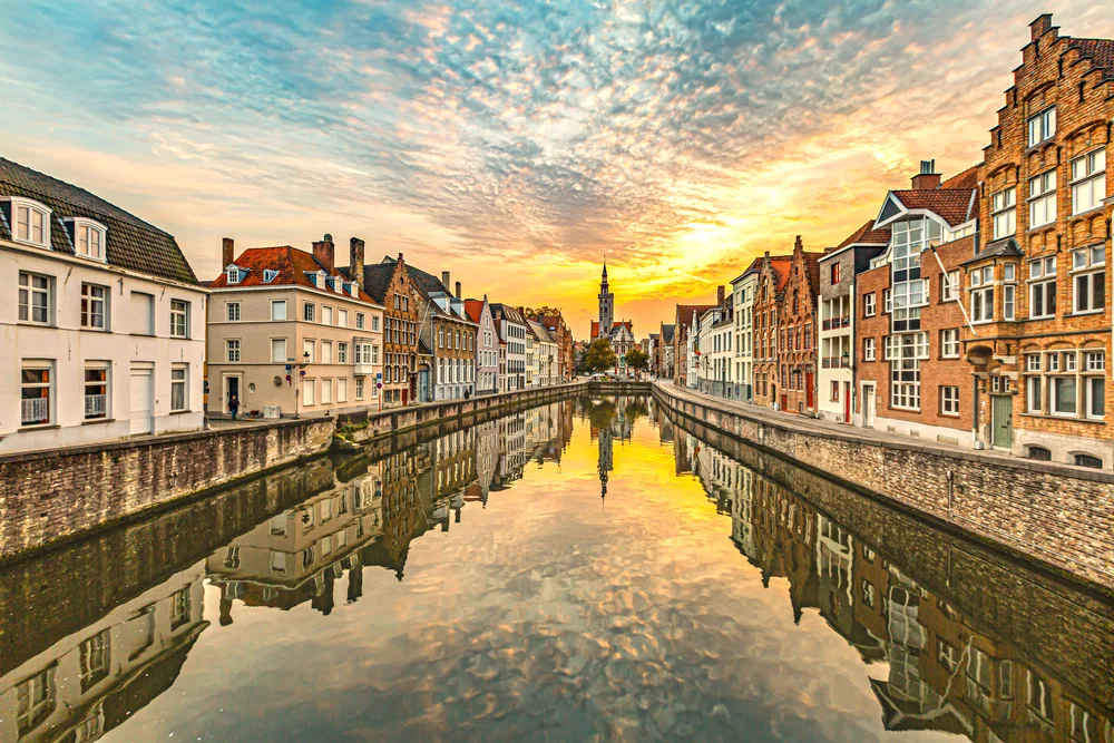 Neat dusk photo of Bruges, one of the best areas to stay in Belgium, with its still canals that are used as roads